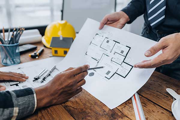 Two workers discussing the design and construction of a new project